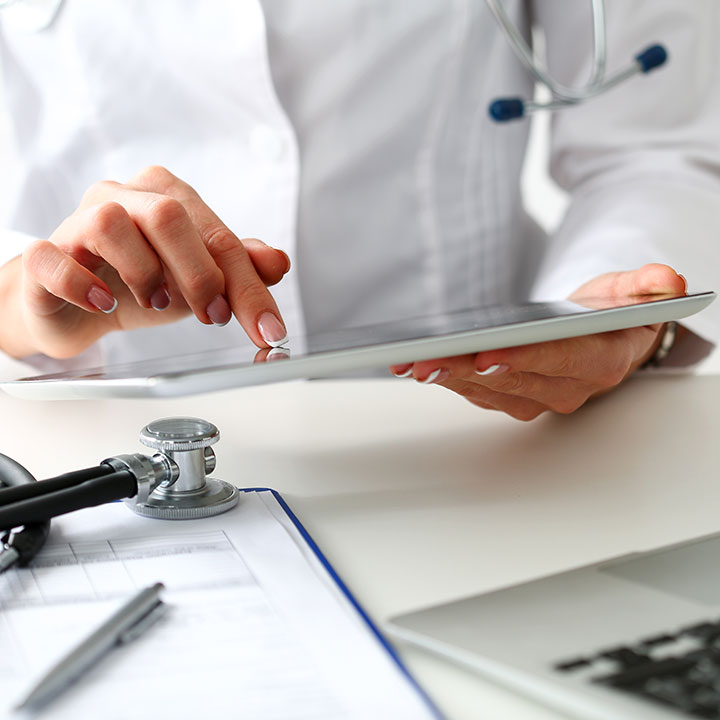 Surgical Physician using a tablet